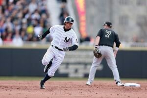 A New York Yankees player sprints past second base during a tense moment on the field, with a Red Sox player in the background. Captured amid a packed stadium, the image reflects the frustration of Yankees fans as their team's playoff hopes take a hit following a painful sweep by Boston — a fresh blow to the Bronx faithful in the 2025 season.